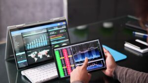 A pic of a laptop and screen displaying analytics for google analytics and tag manager