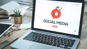 A laptop with the screen reading Social Media for the blog How to Create a Winning Social Media Strategy in 2025.